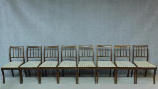 A set of eight Regency style mahogany dining chairs with splat backs on sabre supports. H.85cm