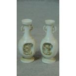 A pair of antique white Chinese porcelain urn vases with sculpted blossom branches. H.17cm