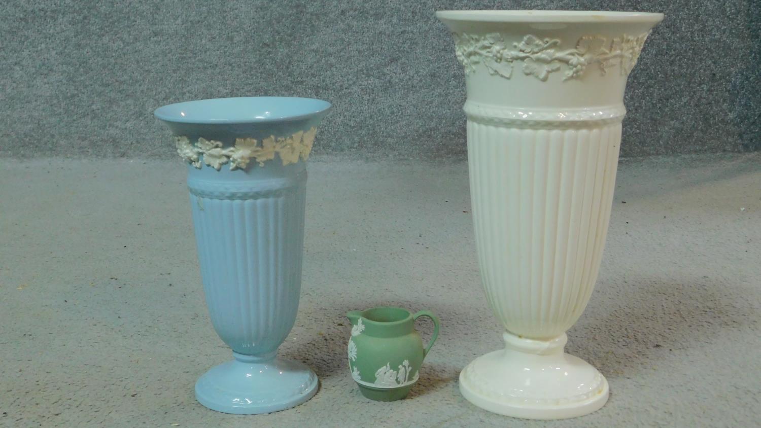 A collection of antique Wedgwood including two embossed Queensware trumpet vases along with a dark