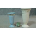 A collection of antique Wedgwood including two embossed Queensware trumpet vases along with a dark