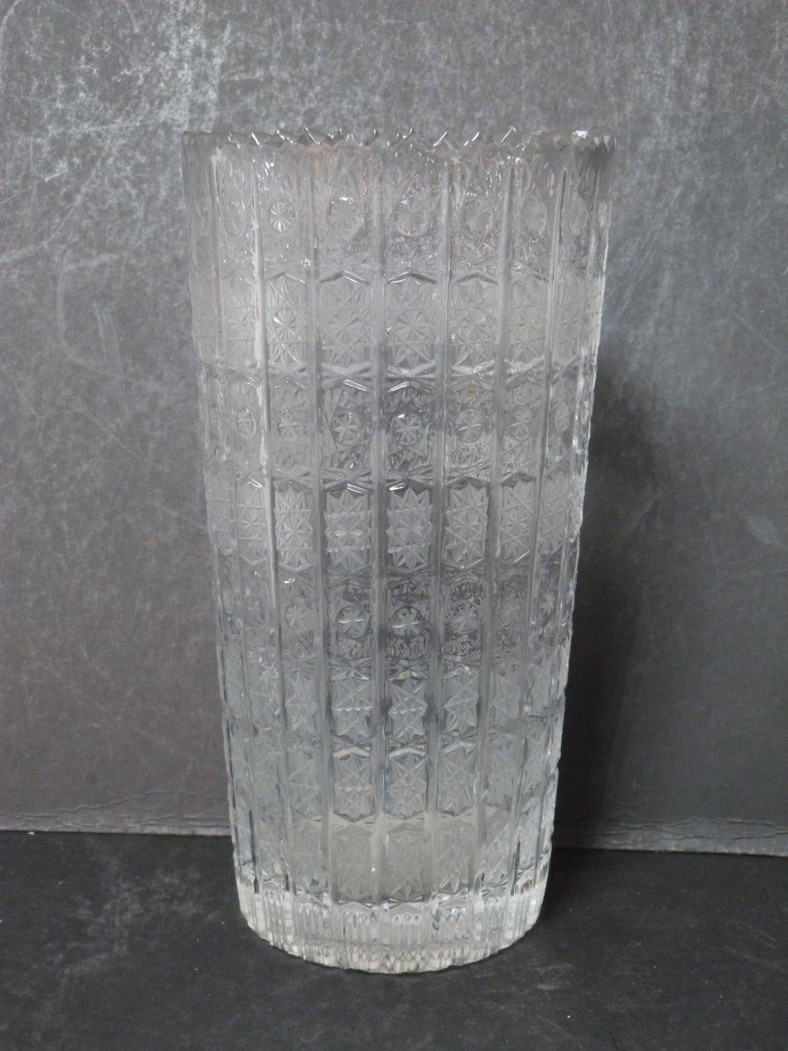 A ribbed antique Bohemian star cut engraved crystal vase with a zig zag edge. h29.5cm.