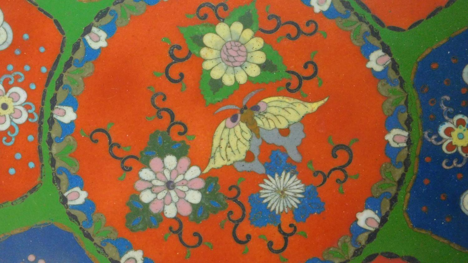 A Meji period Cloisonné enamel plate with red and blue panels on a green background decorated with - Image 3 of 5