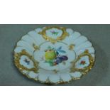 A Meissen handpainted and gilded fruit plate, with central cartouche depicting a lemon, plum,