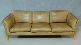 A vintage tan leather three seater sofa. H.64 W.207 D.77cm