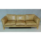 A vintage tan leather three seater sofa. H.64 W.207 D.77cm