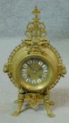 A 19th century French pierced brass mantle clock with ormolu mounts including two lion head