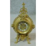 A 19th century French pierced brass mantle clock with ormolu mounts including two lion head