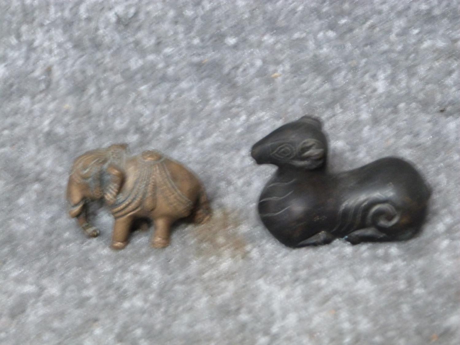 A collection of metal items and a carved carnelian deer. Including a bronze scroll weight in the - Image 4 of 12