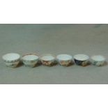 A collection of six antique hand painted porcelain tea bowls. Including four Chinese hand painted