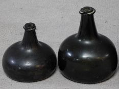 Two 17th to early 18th century green glass onion shaped wine bottles.