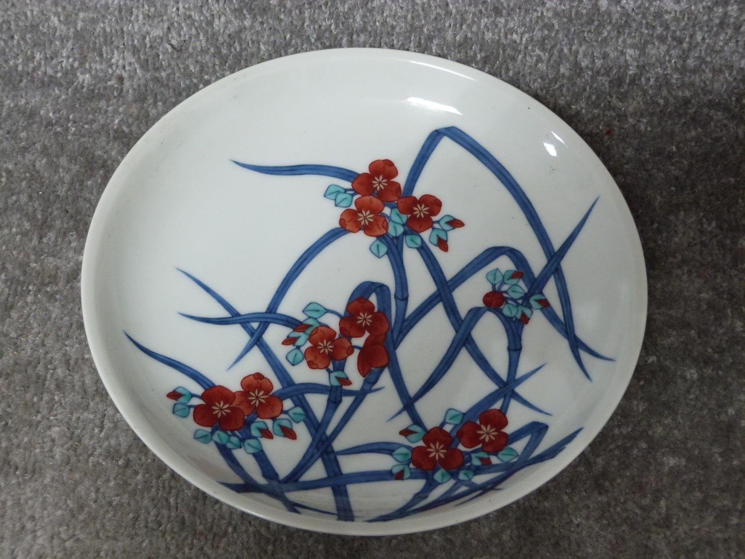 A Meji period Japanese hand painted Nabeshima porcelain plate with floral design along with a Meji - Image 2 of 11