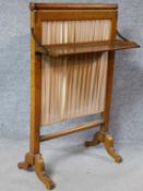 A 19th century bird's eye maple firescreen with folding shelf on cabriole supports. H.88 W.55 D.29cm