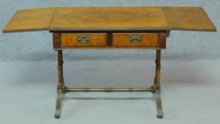 A Regency style figured walnut sofa table with two frieze drawers on reeded stretchered swept