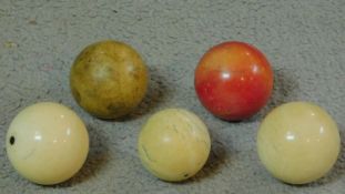 A collection of five Victorian ivory billiard/snooker balls. One dyed red.