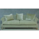 A contemporary scroll arm sofa in beige upholstery on block feet. H.67 W.220 D.100cm