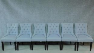 A set of six contemporary dining chairs in powder blue buttoned back upholstery on square