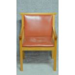 A contemporary oak framed armchair upholstered in red leather. H.83cm