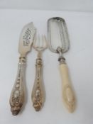 A set of antique repousse silver plated fish servers and a silver plated crumb scoop with carved
