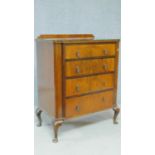 A mid 20th century figured walnut chest of four graduating drawers on cabriole supports. H.108 W.