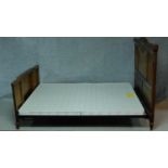 A French Art Deco carved walnut bedstead. H.135 W.220 D.150cm
