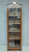 An Georgian style figured walnut and crossbanded narrow library bookcase with glazed door