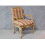 A Louis XV style carved beech fauteuil armchair with matching pillow on cabriole supports. H.91cm