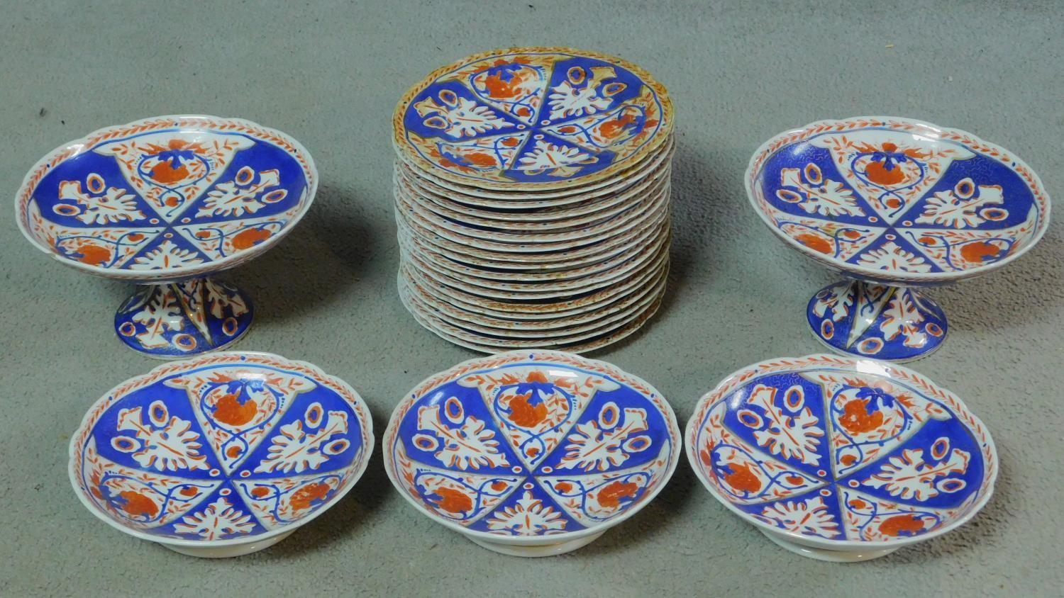 A collection of eighteen antique hand painted and gilded porcelain plates, three footed bowls and