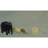 A collection of antique ivory and carved items. Including an ebony elephant with carved detaling,