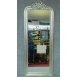 A silvered frame moulded pier mirror with foliate cresting and detail. 179x70cm