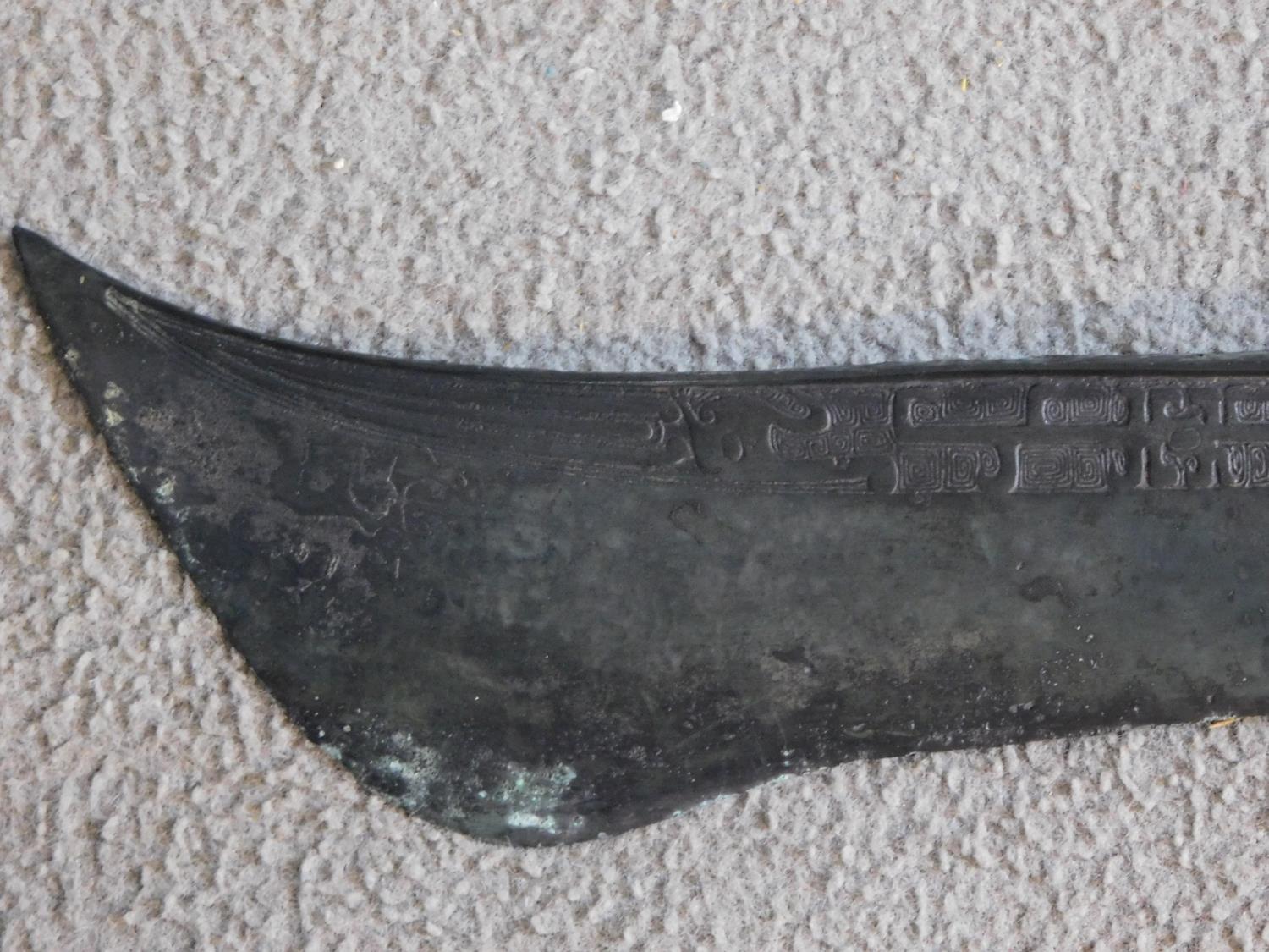 A Chinese bronze ceremonial blade with impressed marks and horse head finial to the handle. W.46cm - Image 2 of 6