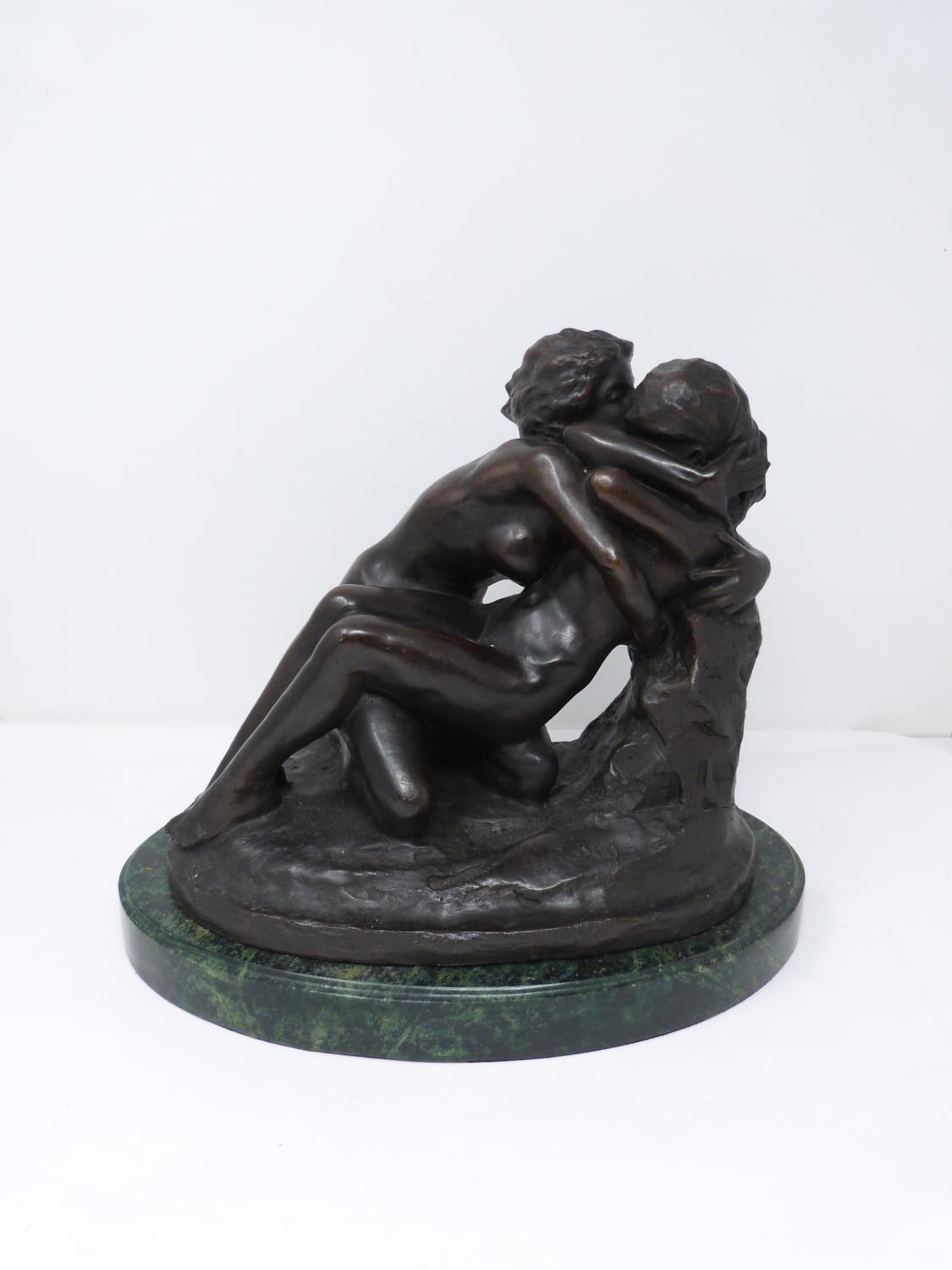 A bronze sculpture after Rodin's 'The Metamorphosis of Ovid' mounted on a green serpentine base.