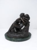 A bronze sculpture after Rodin's 'The Metamorphosis of Ovid' mounted on a green serpentine base.