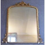 A 19th century carved giltwood overmantel mirror with scrolling foliate cresting above original