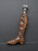 A French antique repoussé floral design silver topped seal in the form of a carved wooden knee boot.