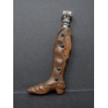 A French antique repoussé floral design silver topped seal in the form of a carved wooden knee boot.