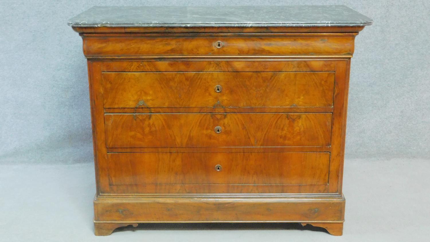 A late 19th century French Louis Philippe burr walnut commode with grey veined marble top and four