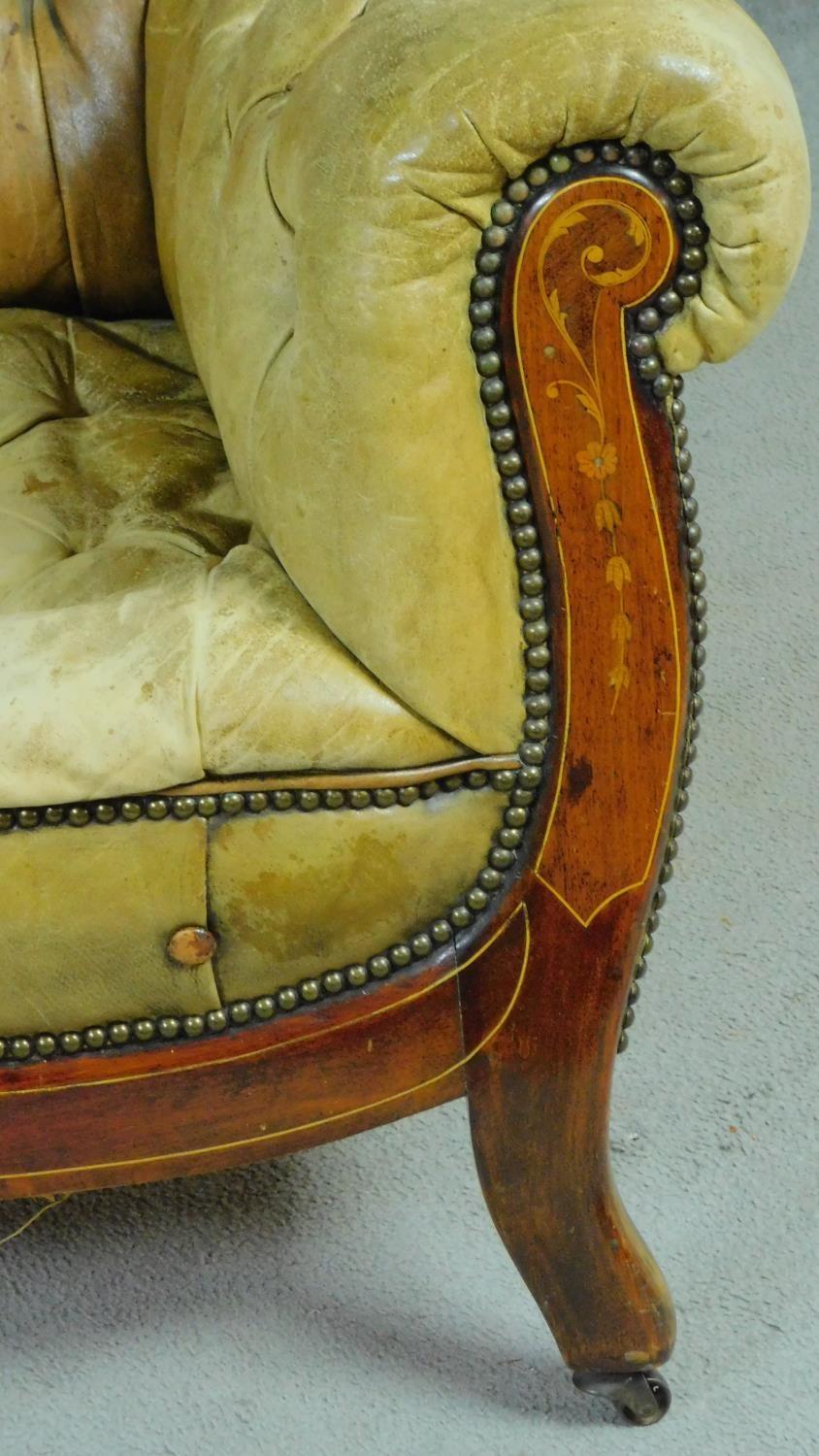 A pair of late 19th century mahogany and satinwood inlaid club armchairs in deep buttoned leather - Image 5 of 10