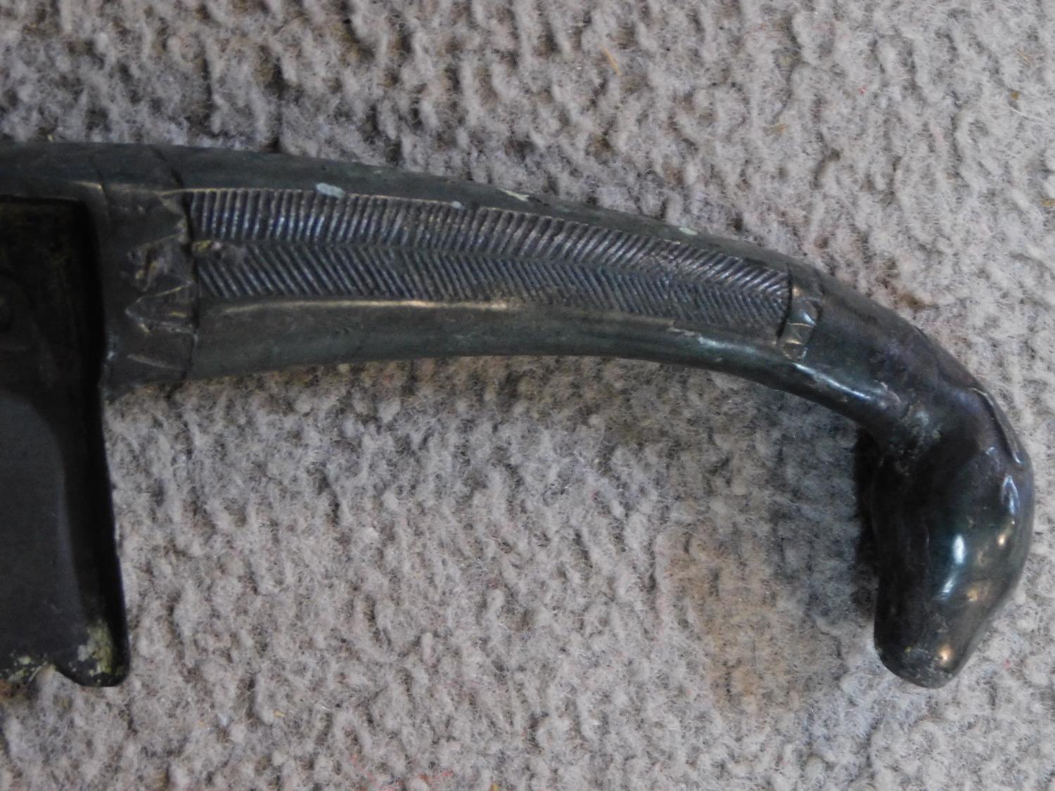 A Chinese bronze ceremonial blade with impressed marks and horse head finial to the handle. W.46cm - Image 4 of 6
