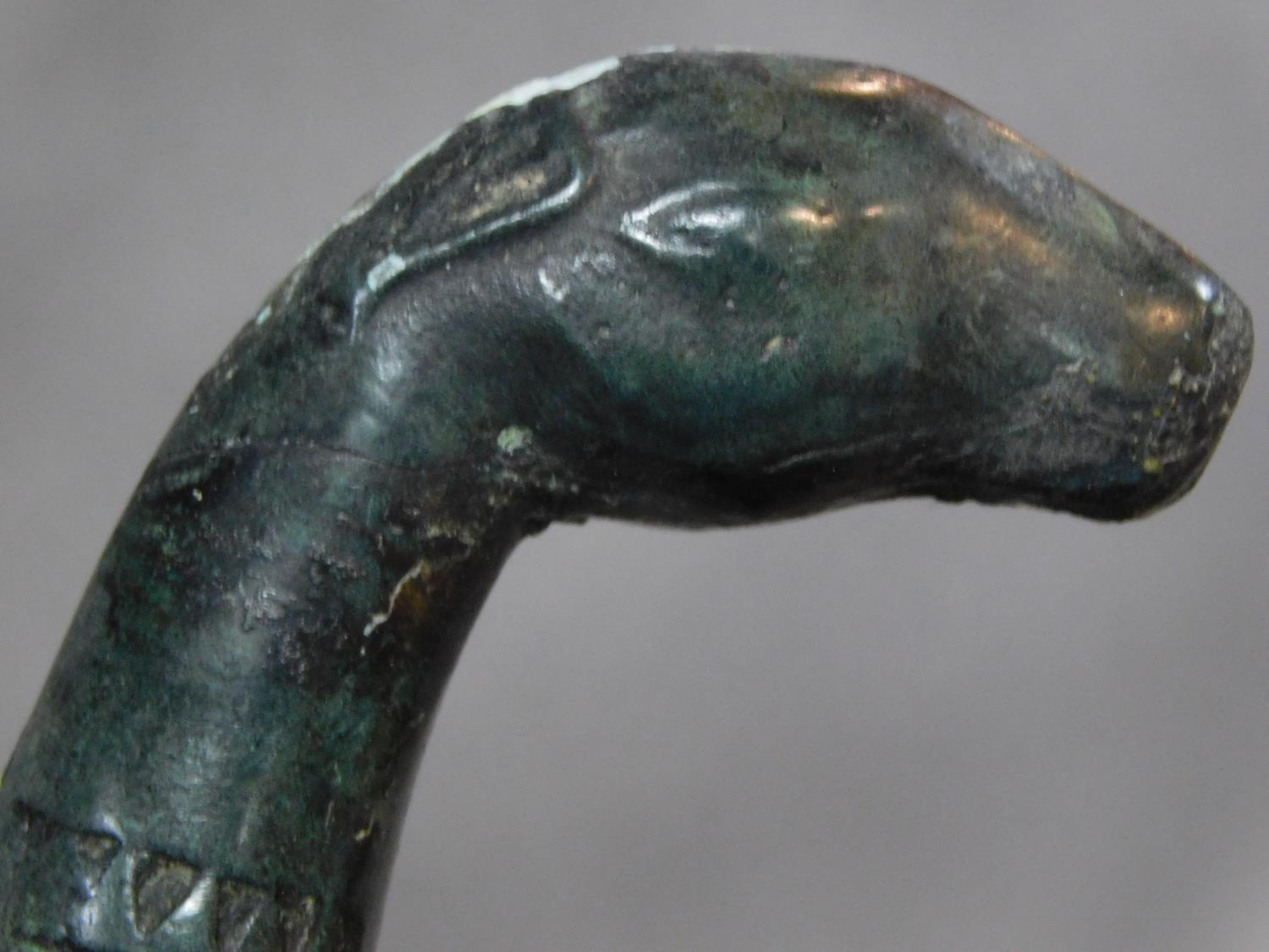 A Chinese bronze ceremonial blade with impressed marks and horse head finial to the handle. W.46cm - Image 5 of 6