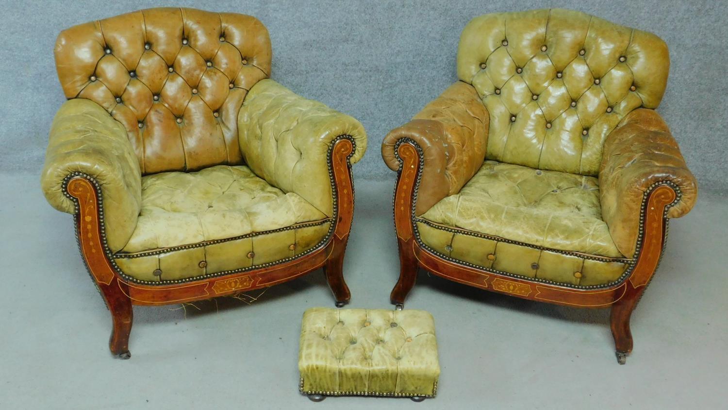 A pair of late 19th century mahogany and satinwood inlaid club armchairs in deep buttoned leather