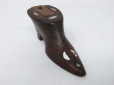 A 19th century carved wooden snuff box in the form of a heeled boot with mother of pearl inlay and