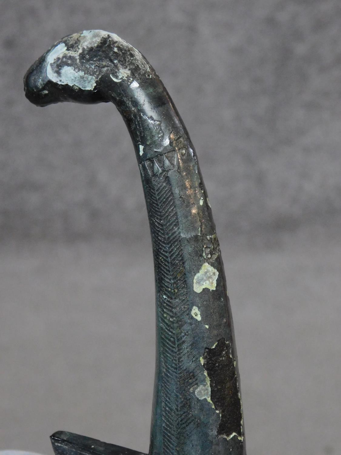 A Chinese bronze ceremonial blade with impressed marks and horse head finial to the handle. W.46cm - Image 6 of 6