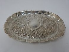 A Georgian silver repoussé tray with crossed cornucopia and floral design, stylised petal form edge.