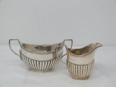 A Victorian dragooned silver milk jug and sugar bowl set. With rope design to the rim. Hallmarked: