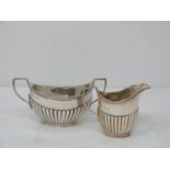 A Victorian dragooned silver milk jug and sugar bowl set. With rope design to the rim. Hallmarked: