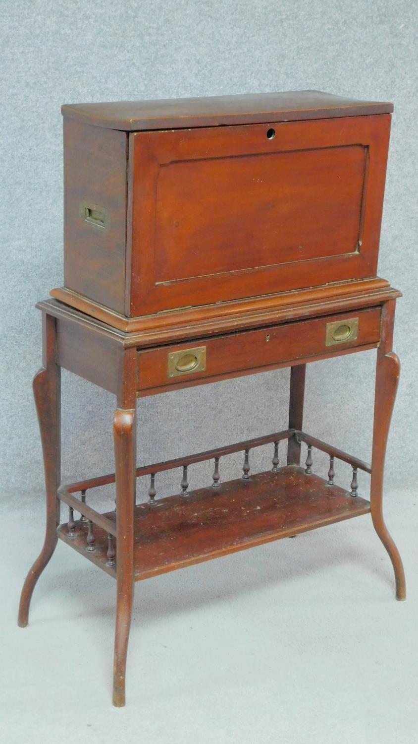 A late Victorian mahogany secretaire stationery cabinet on stand with fall front revealing fitted