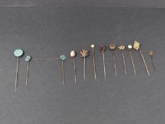 A collection of eleven antique silver, yellow metal and 9ct gold stick pins. Including a diamond