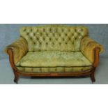 A late 19th century mahogany and satinwood inlaid two seater sofa in deep buttoned leather