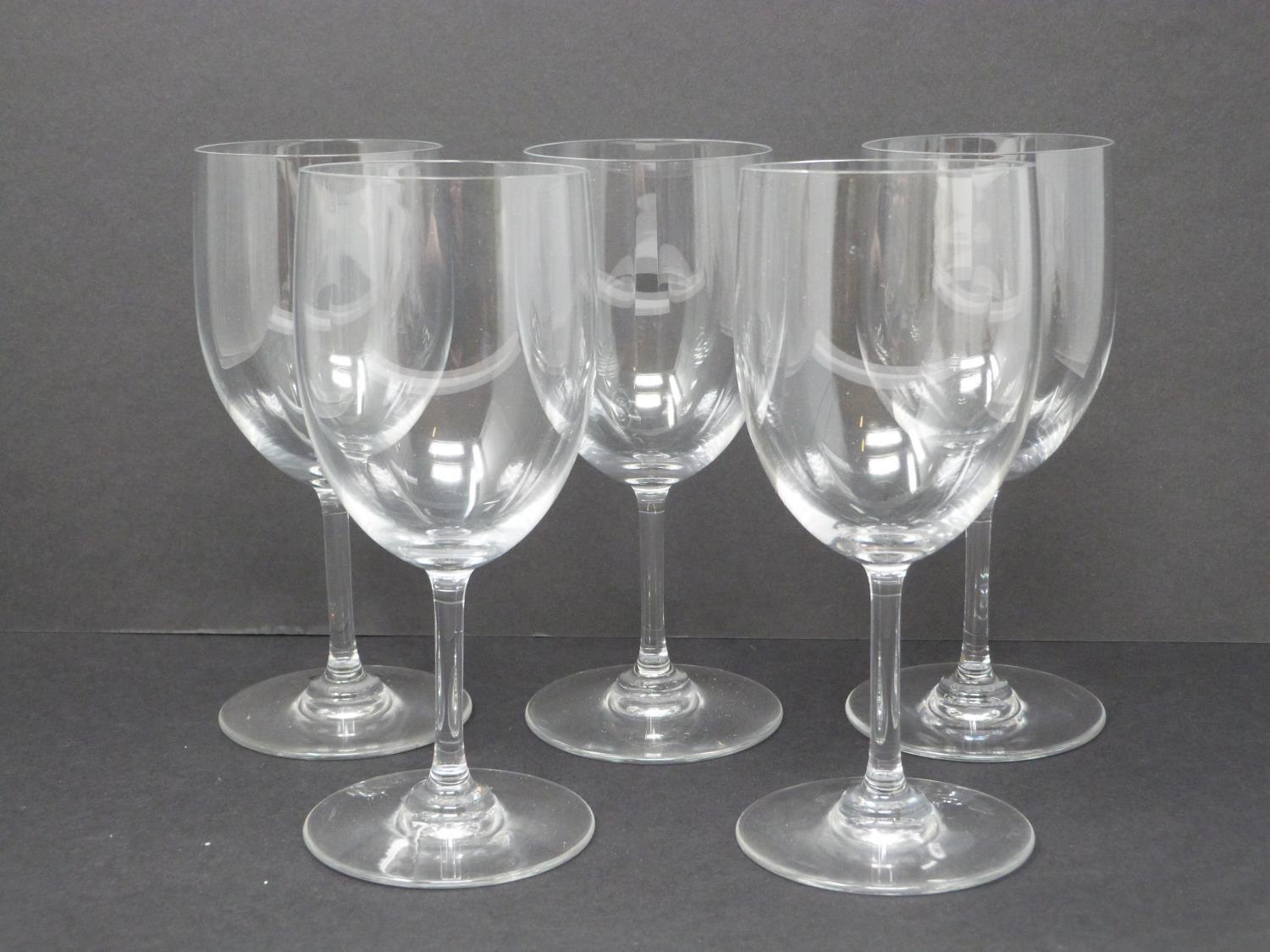 A set of five Baccarat crystal water glasses. Signed and stamped to the foot. H 15.5cm.