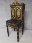 An antique gilt Chinoiserie lacquered Bureau de Dame with panel doors enclosing shelves and